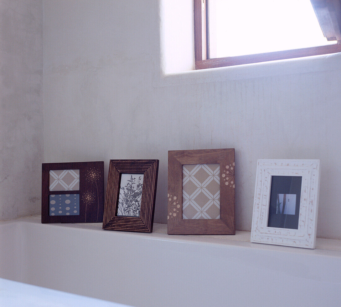 Row of picture frames on a shelf