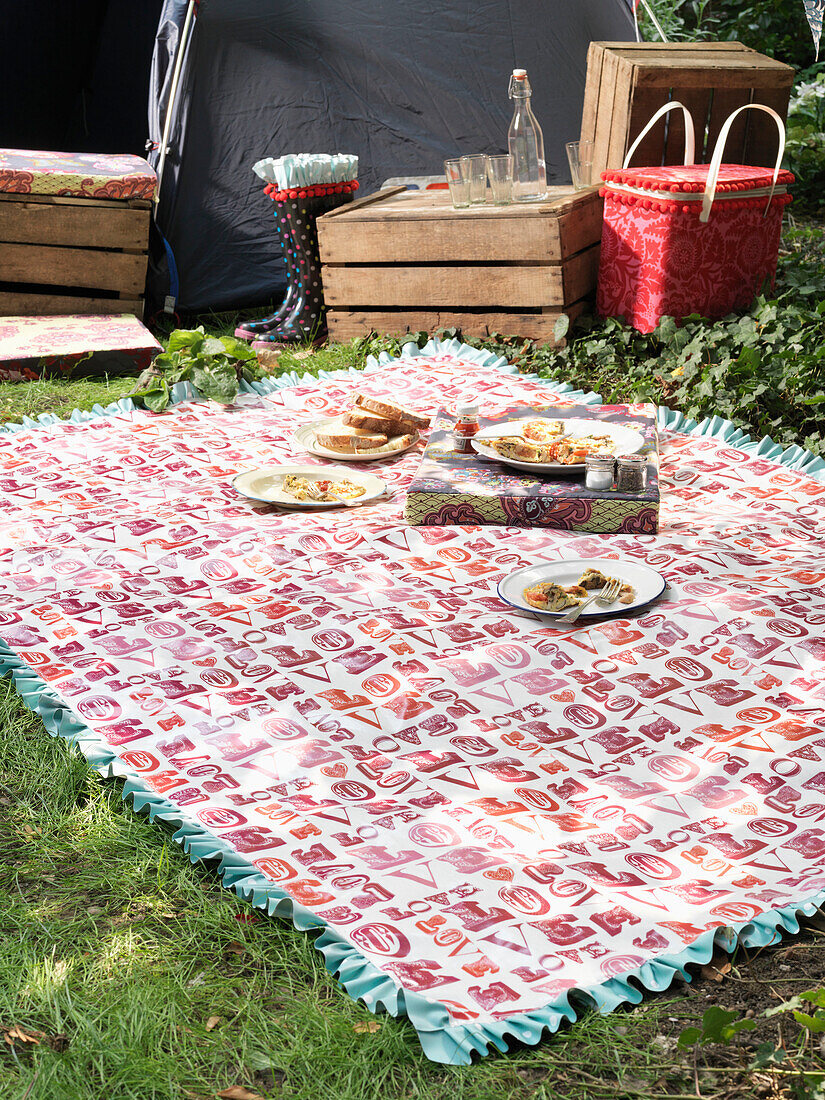 Plates of food on picnic blanket with LOVE London England UK