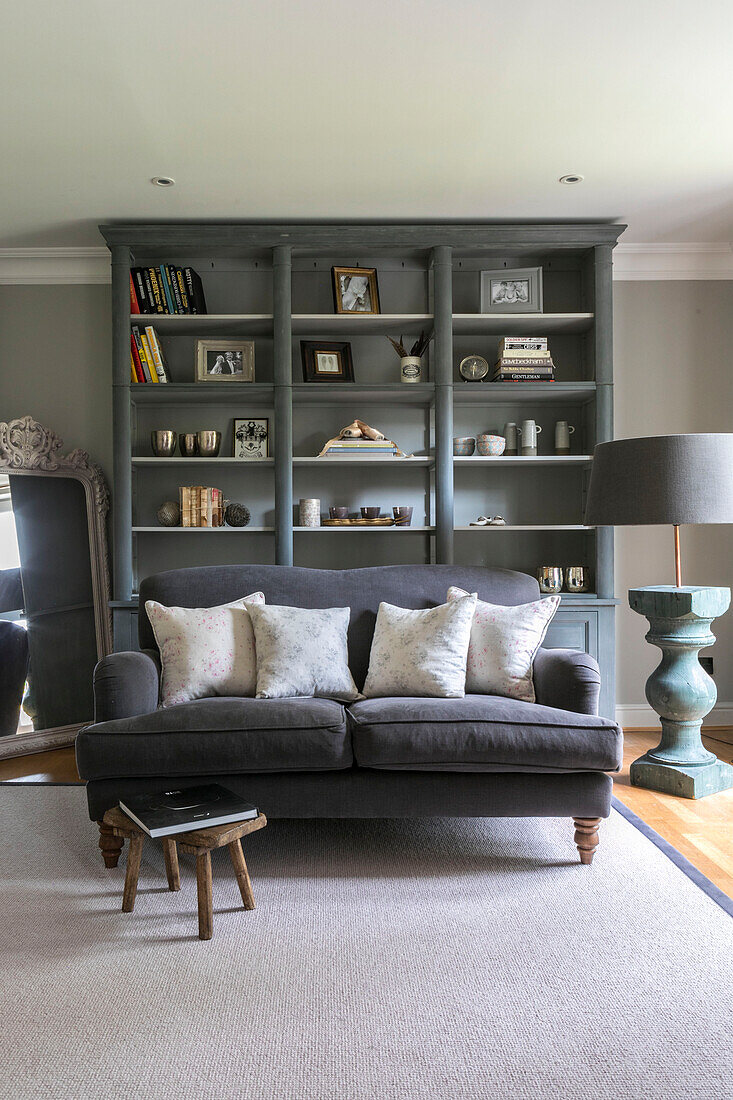 Grey sofa and bookcase in living room of Guildford townhouse Surrey UK