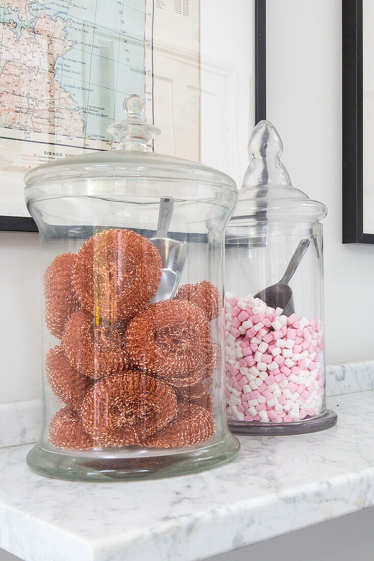 Kitchen scourers and sweets in glass storage jars on shelf in Reading home Berkshire England UK