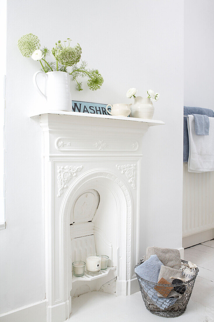 White painted fireplace in a bathroom