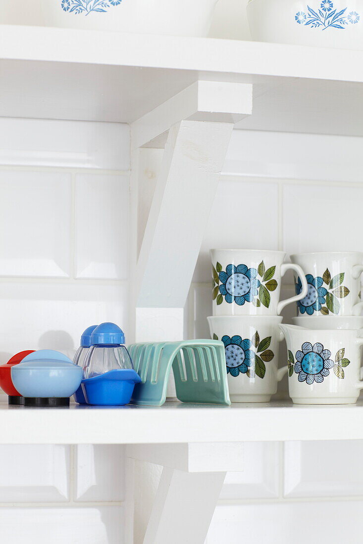 Retro style kitchenware on white shelf in Bembridge home, Isle of Wight, UK