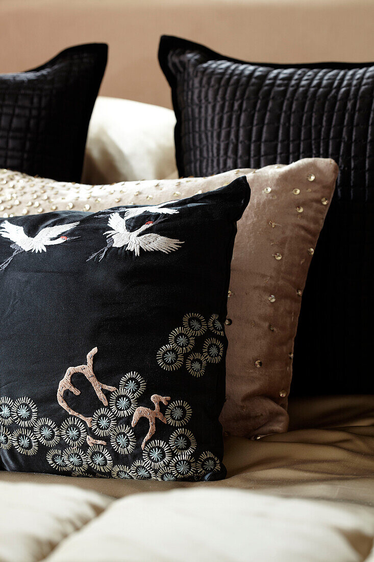 Black and gold embroidered cushions in London home England UK