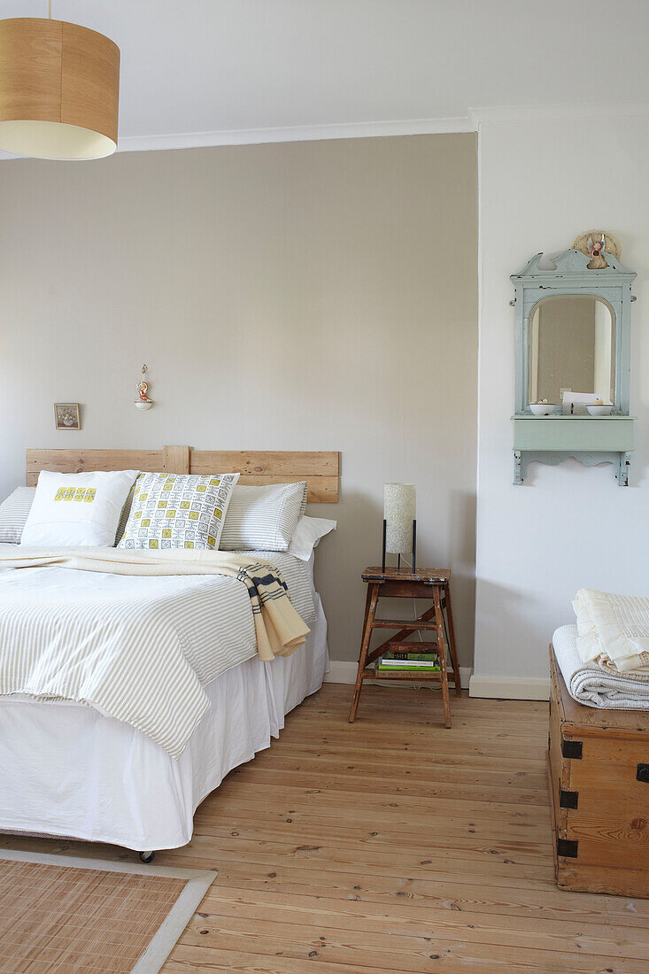 Double bed in room with wooden floorboards in Ryde home Isle of Wight, UK
