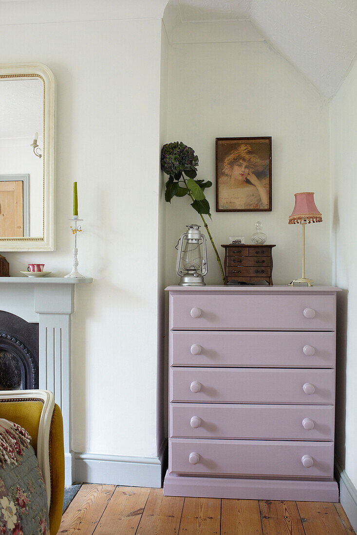 Lilac painted chest of drawers with hurricane lantern in East Cowes home, Isle of Wight, UK
