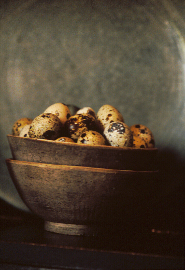 Brown speckled eggs in earthenware bowl