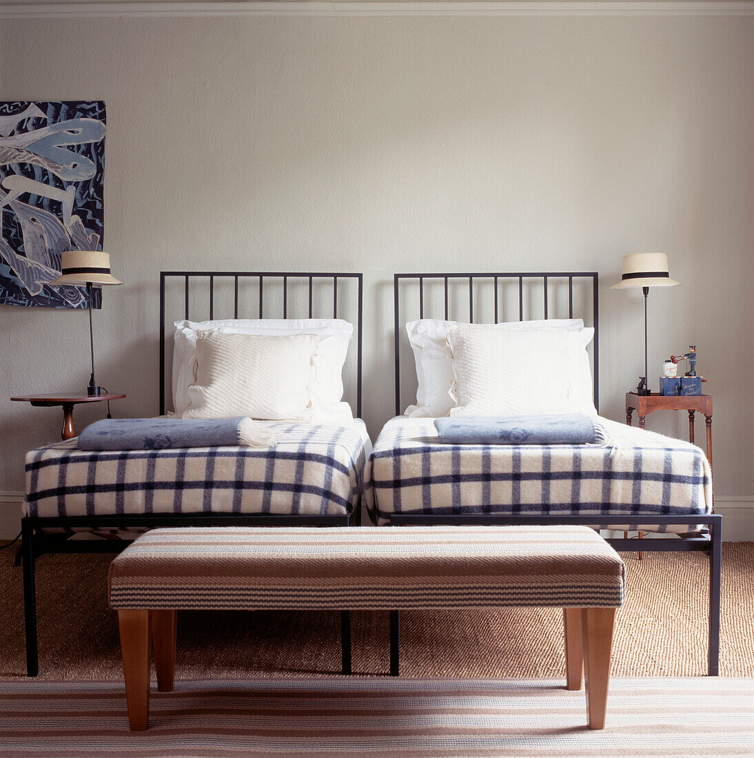Guest bedroom with twin beds and quirky bedside 'hat' lamps and Roger Oates rugs and textiles