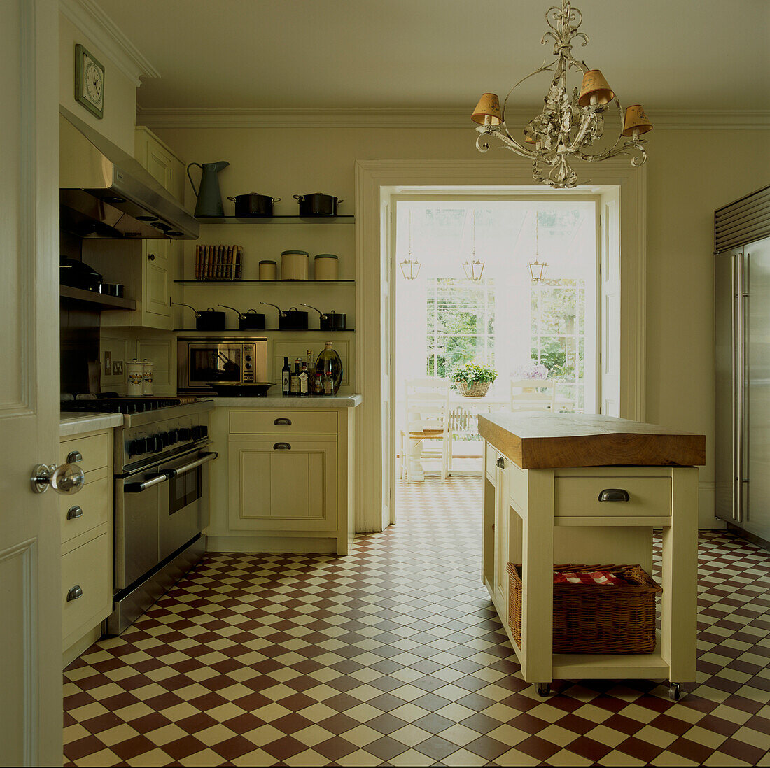 Cream coloured traditional country kitchen with brown and white tiles