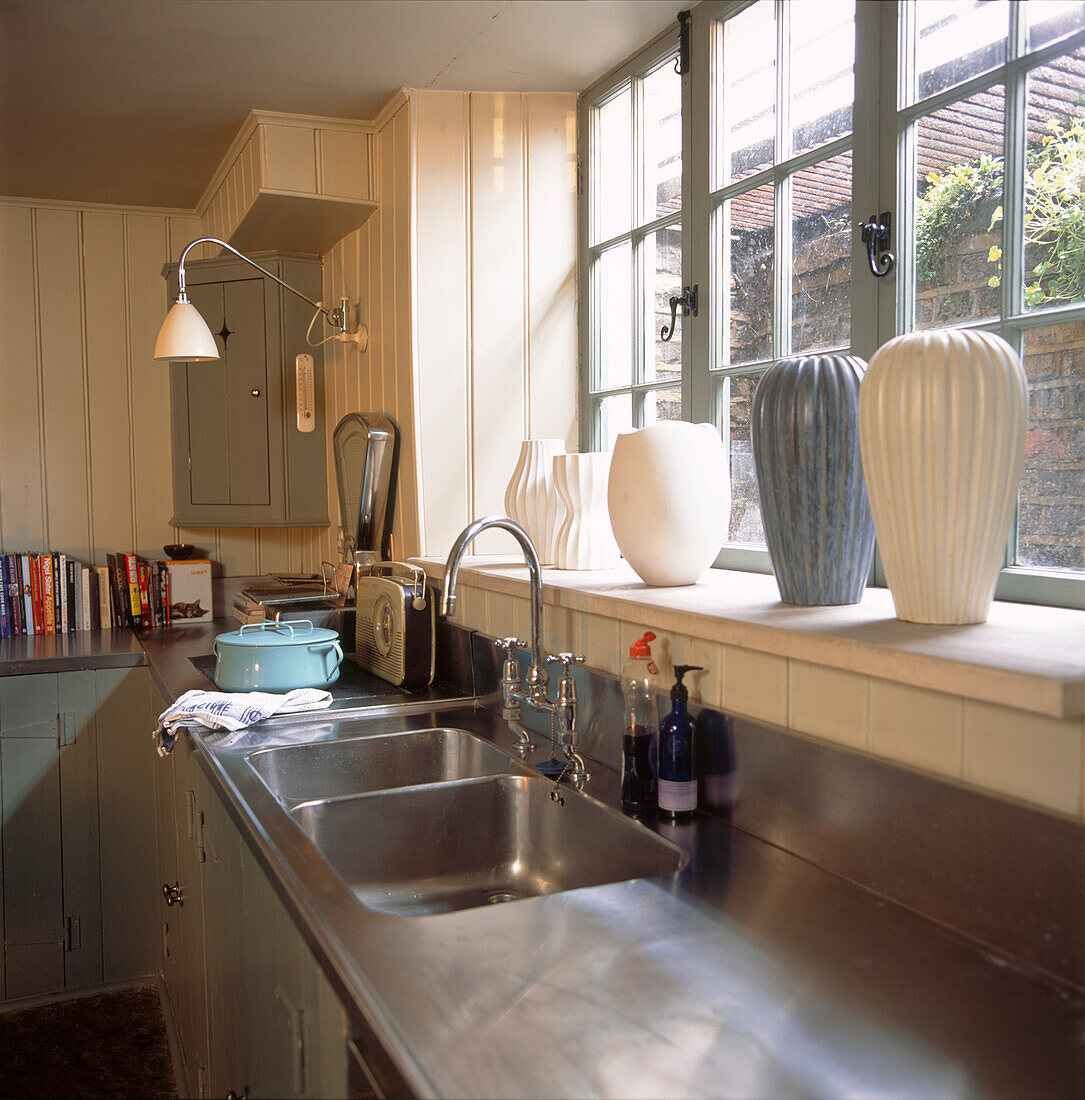 Stainless steel worktop and ceramics in kitchen