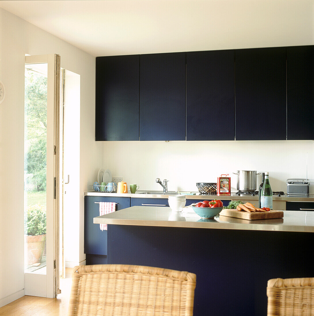 Black modern fitted kitchen diner with garden views