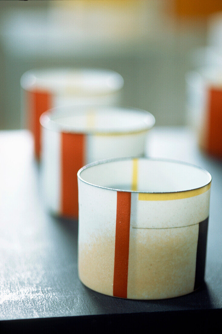 Display of colourful porcelain pots on a tabletop
