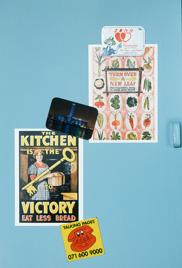 vintage pictures on a light blue cupboard door