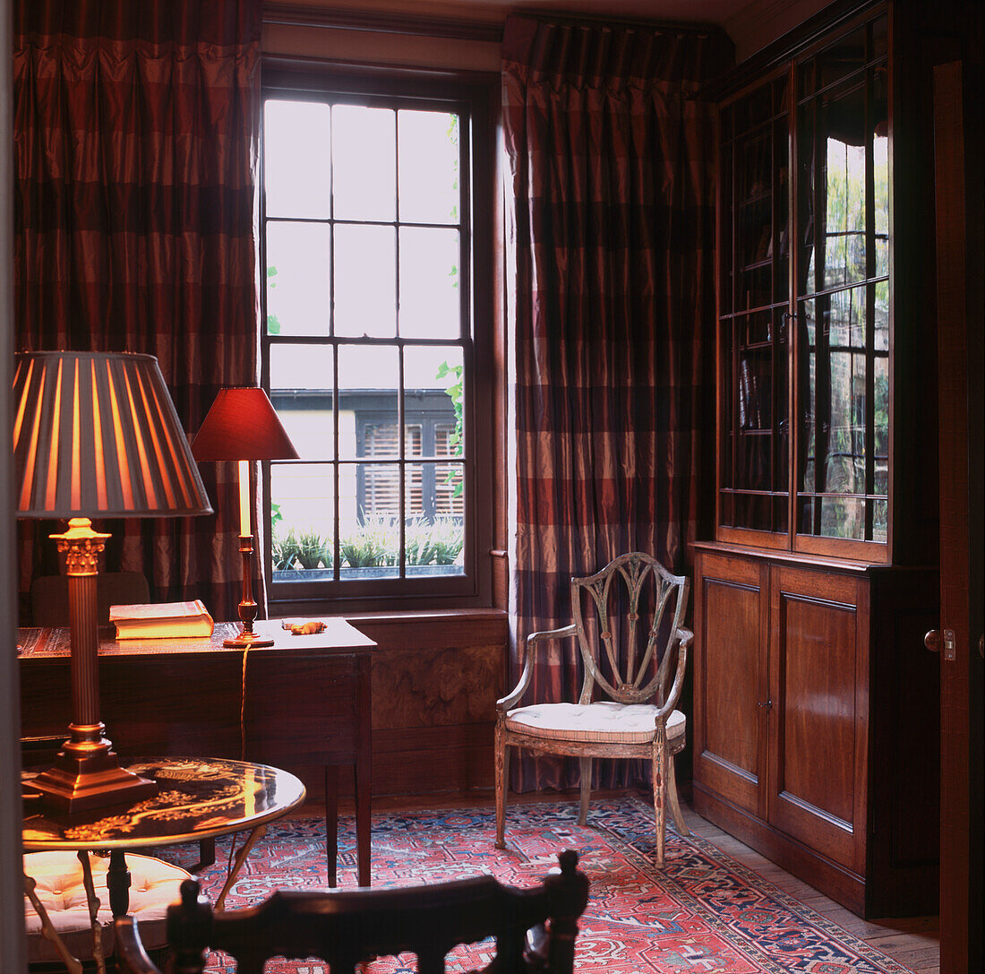 Dark tones in elegant drawing room with antique wooden furniture