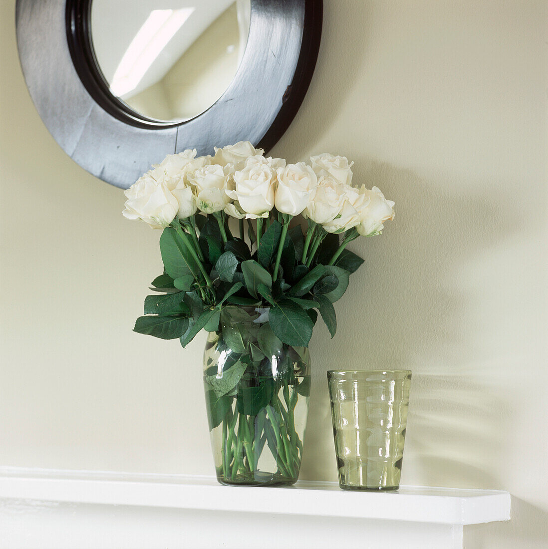 Mantelpiece with flower display and mirror