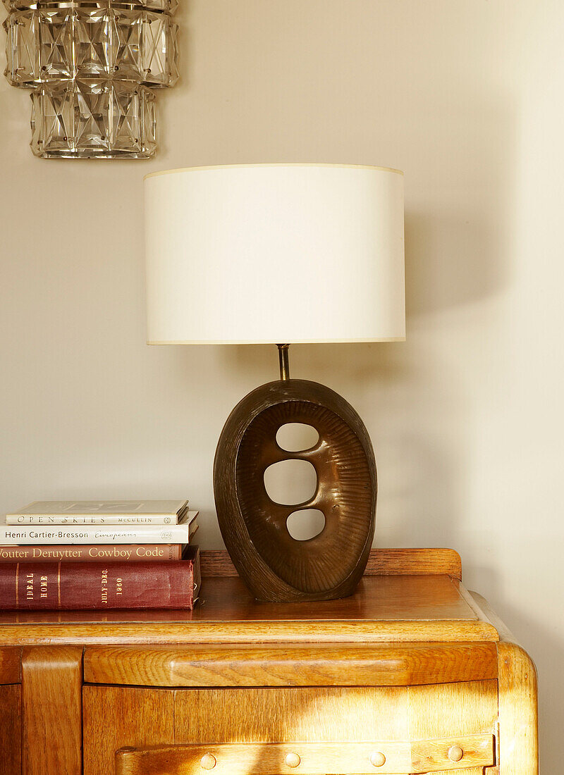 Retro table lamp with white lampshade on a sideboard