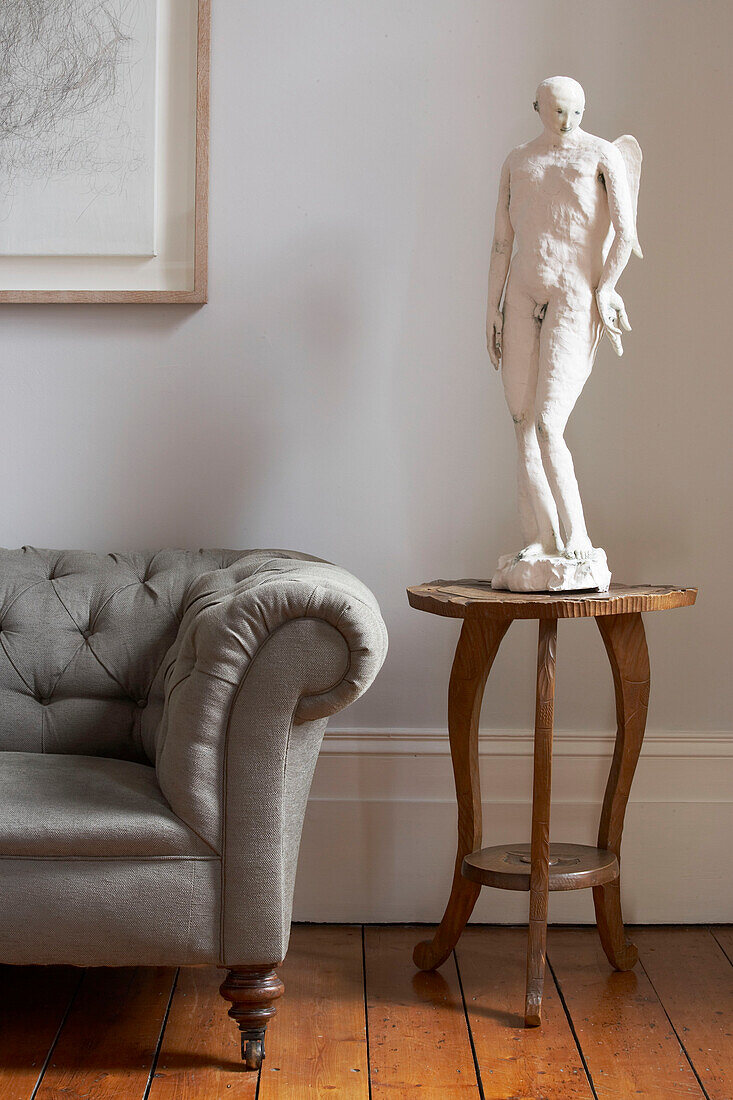 Statue of an angel on side table in London townhouse, UK