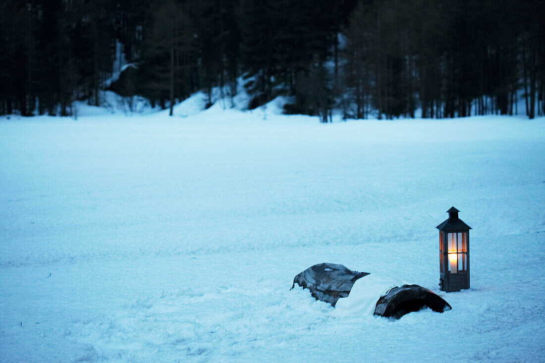 Lit lantern in snow, Zermatt, Valais, Switzerland