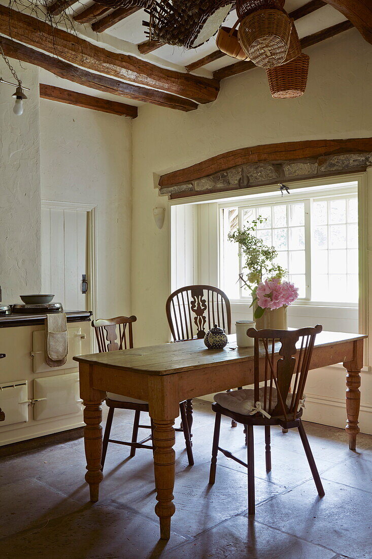 Wooden table at kitchen window in Cumbrian farmhouse, England, UK