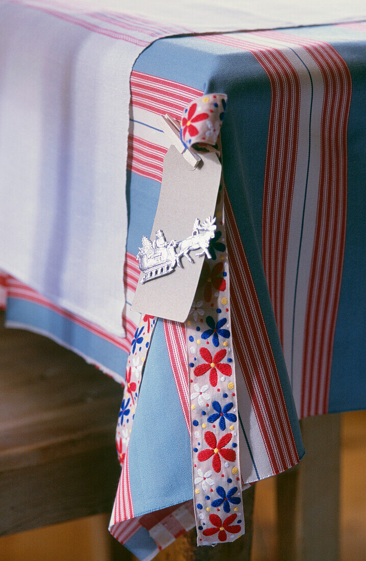 Corner detail of table cloth with Christmas tie