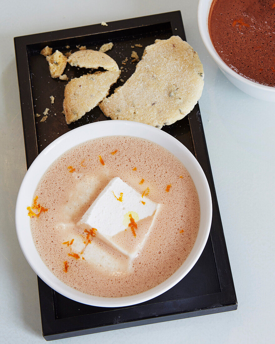 Dark hot chocolate with orange zest and marshmallow and shortbread biscuit