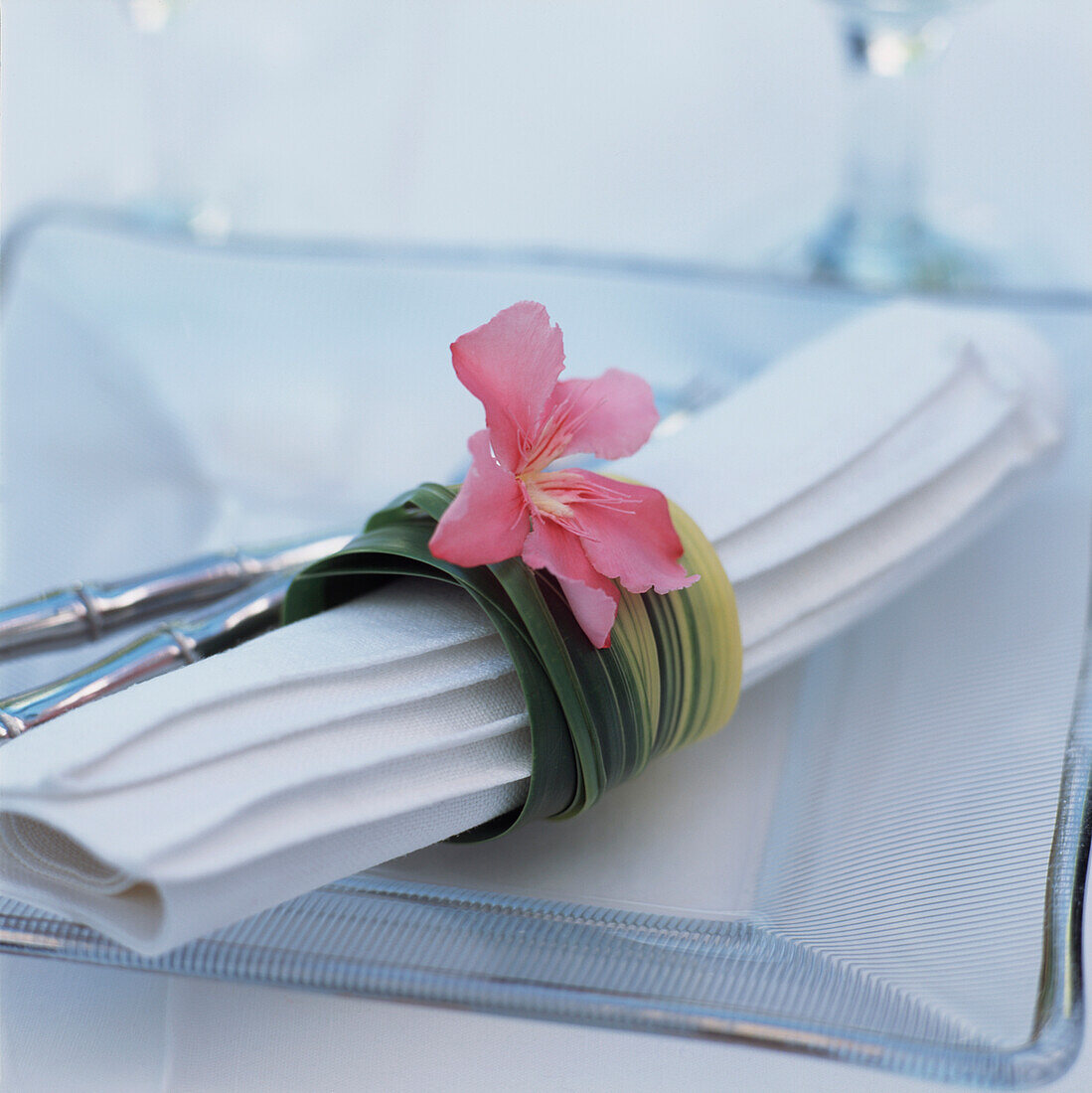 Tabletop place setting and a formal garden dinner party with hand made flower napkin holder