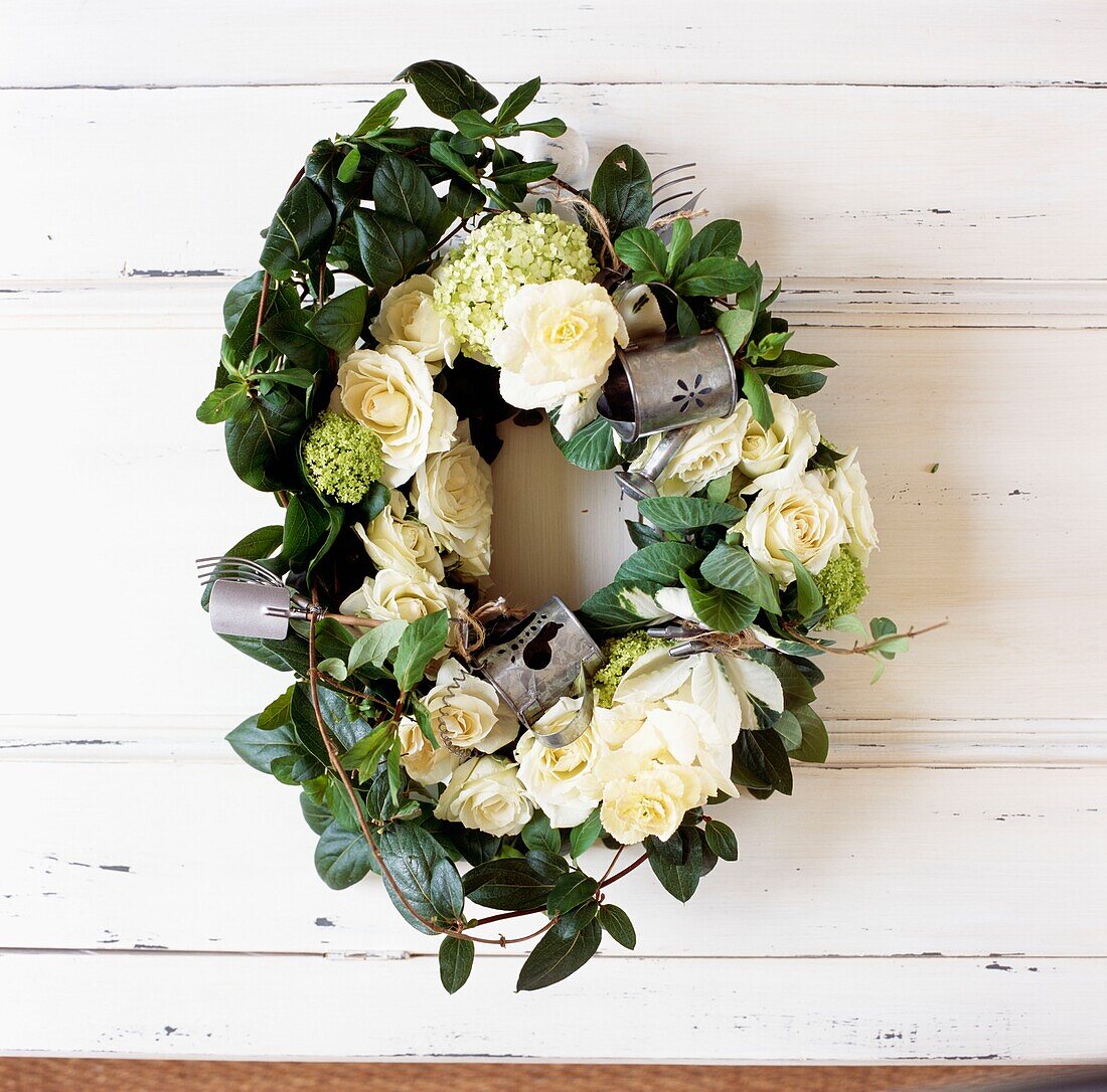 Yellow roses in wreath with metal candle holders