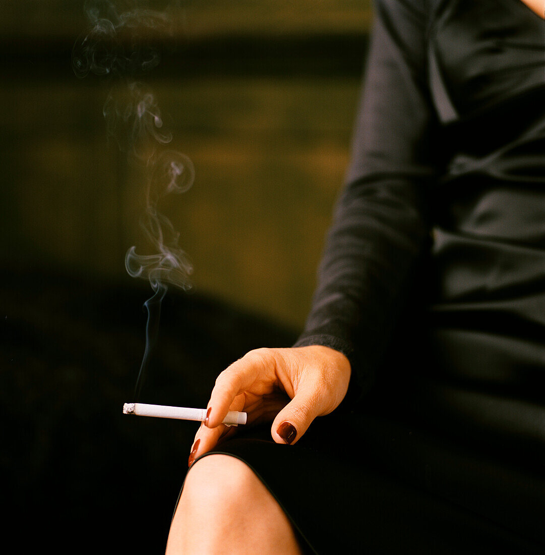 Woman smoking a cigarette in a bar