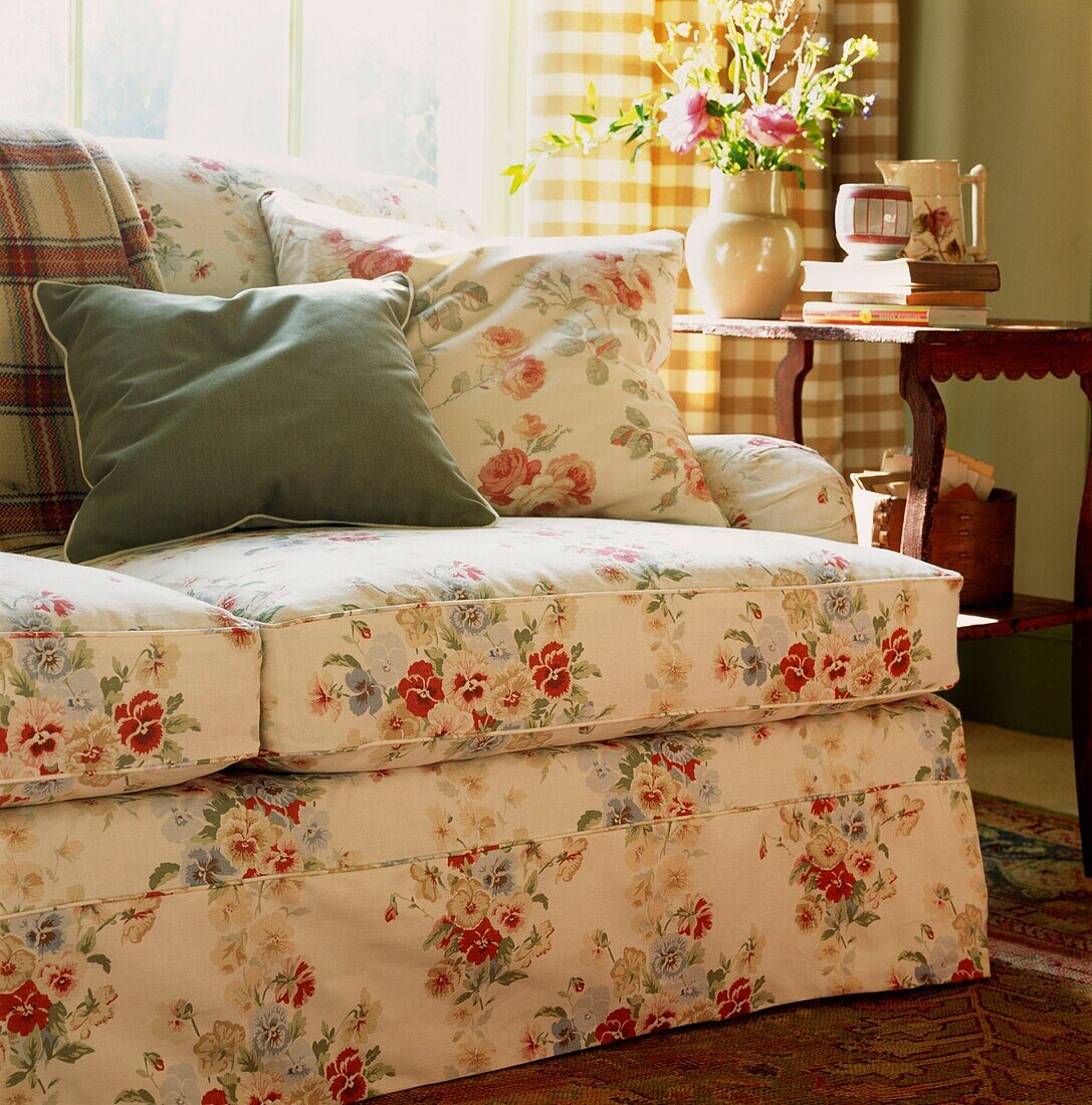 Cushions on floral patterned sofa
