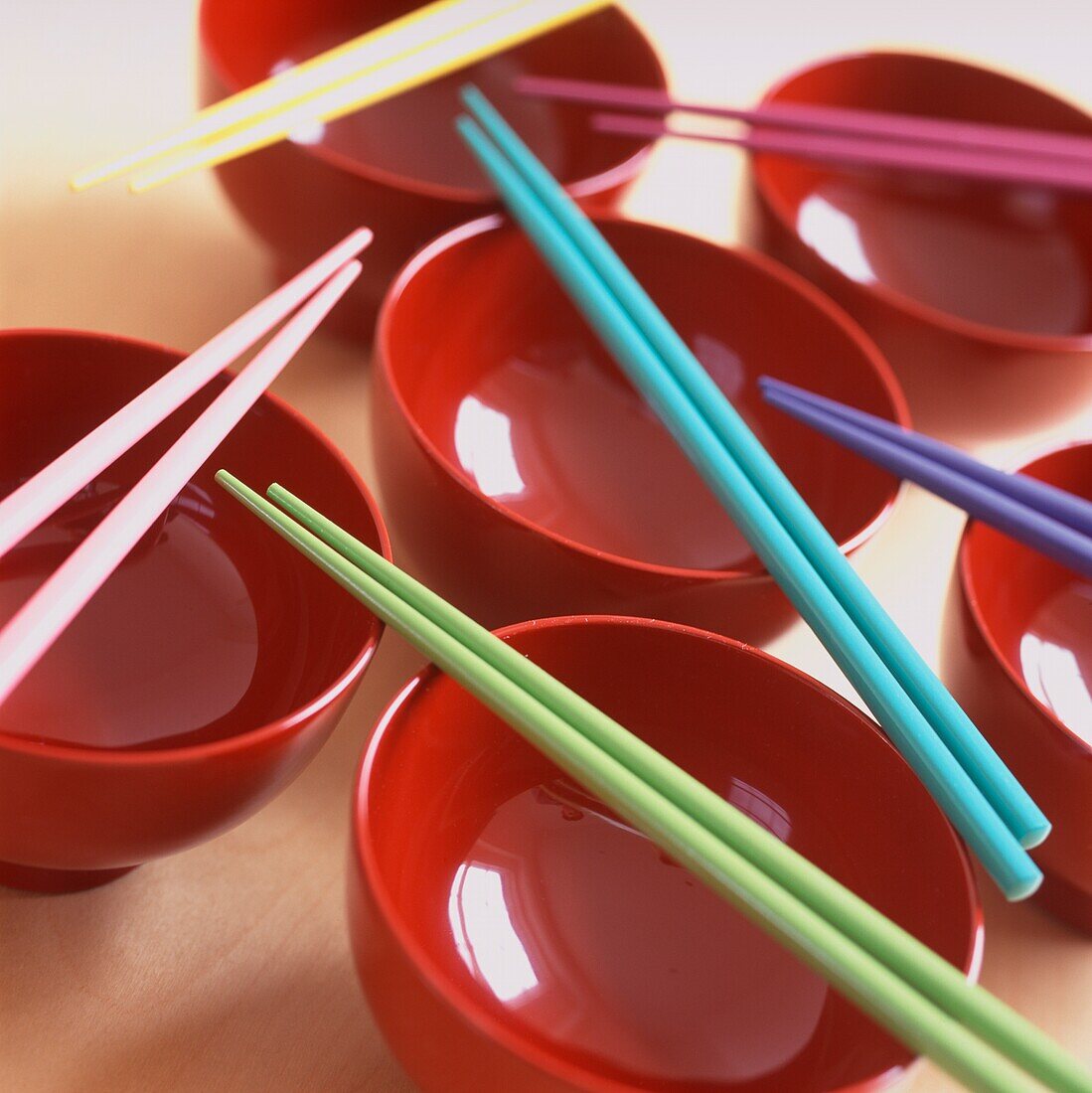 Close up of colourful laquered bowls and chopsticks 