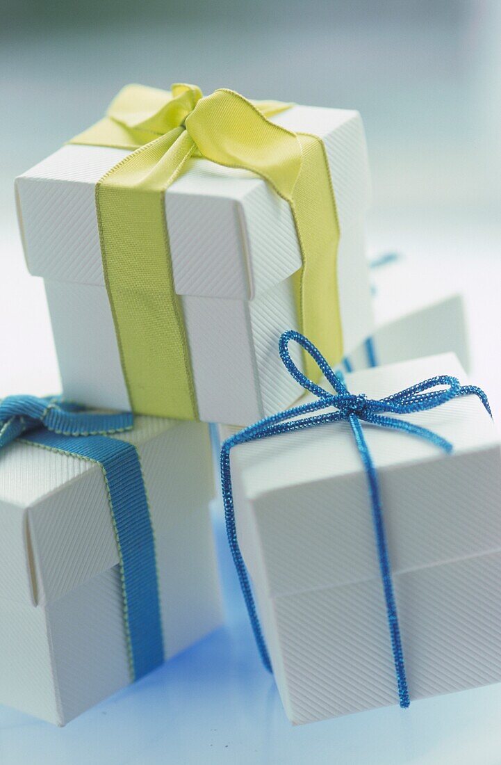 Blue and yellow green ribbon on white favour boxes