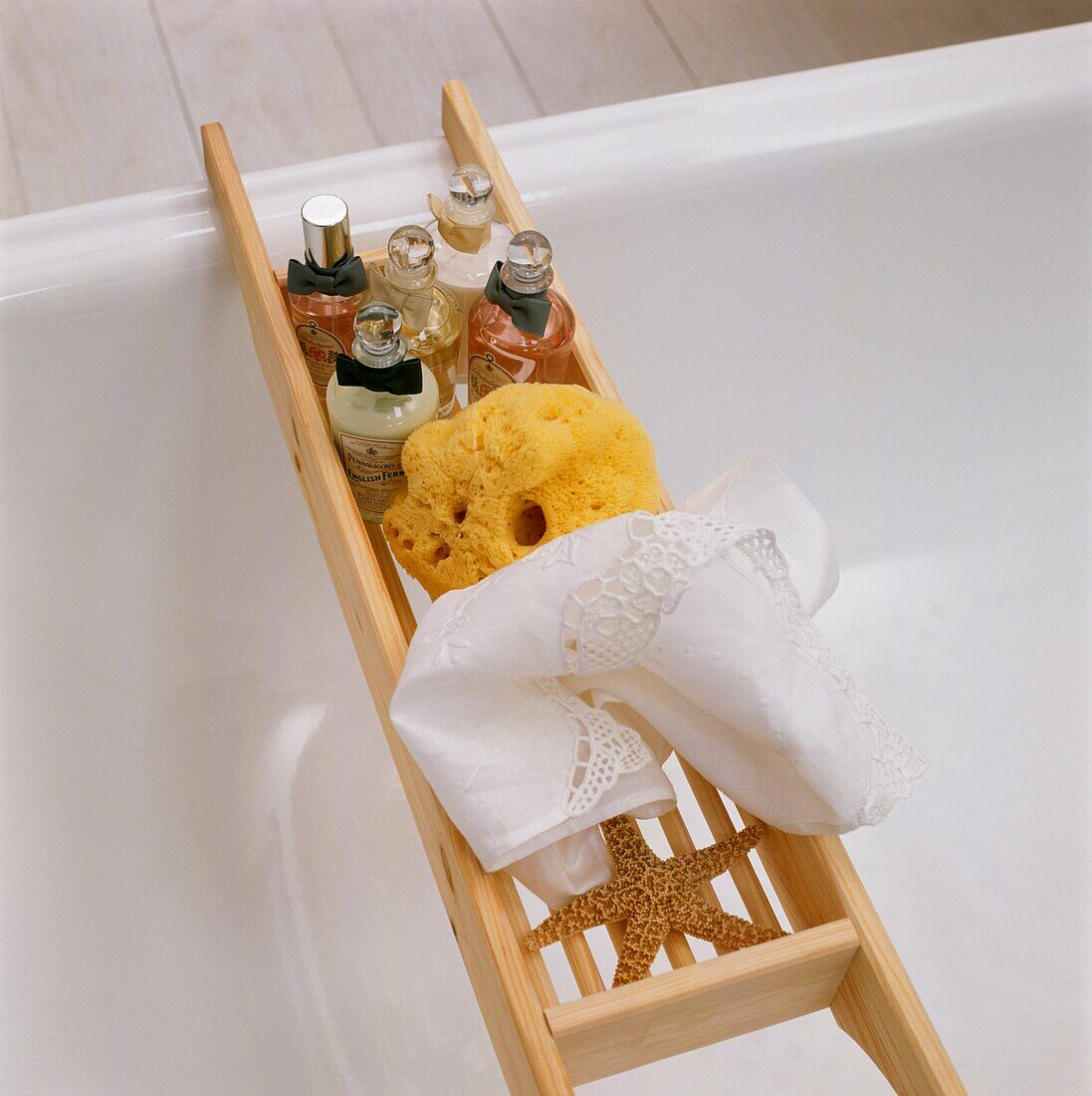 Toiletries and sponge with starfish on bath rack