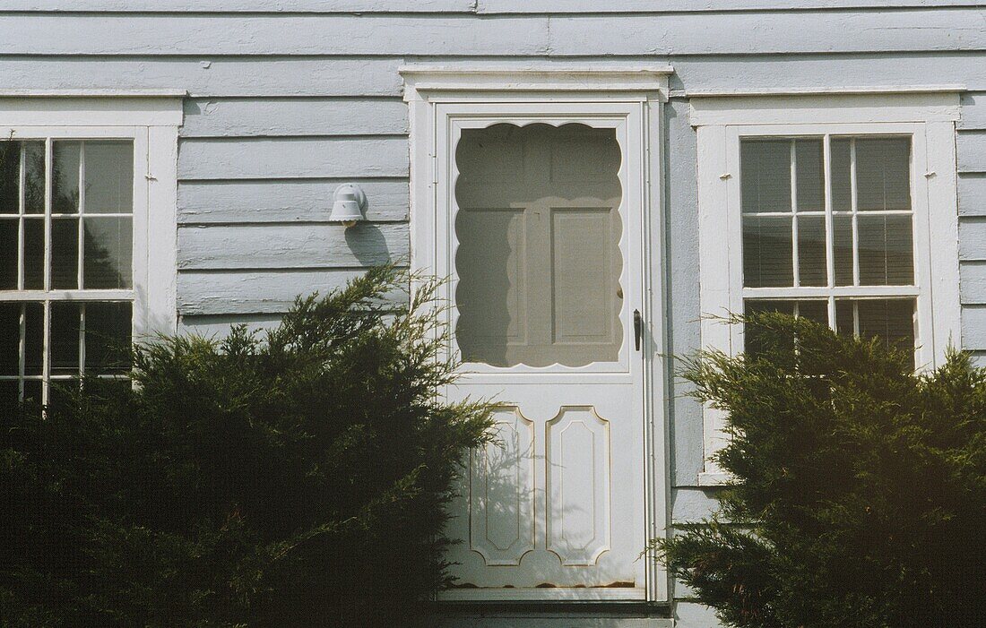 Weather boarded facade with white front door