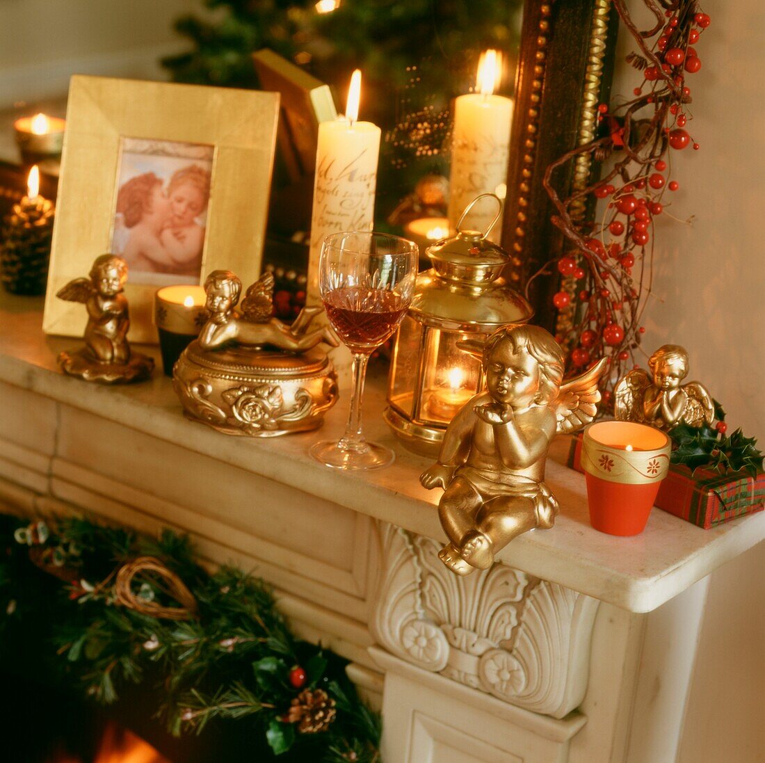 Cherubs on mantlepiece with lantern and berries