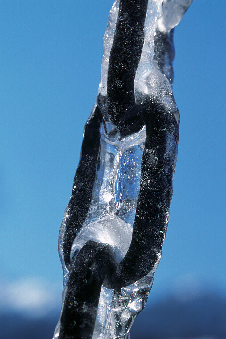 Frozen iron chain against blue skies in the Dolomites Italy