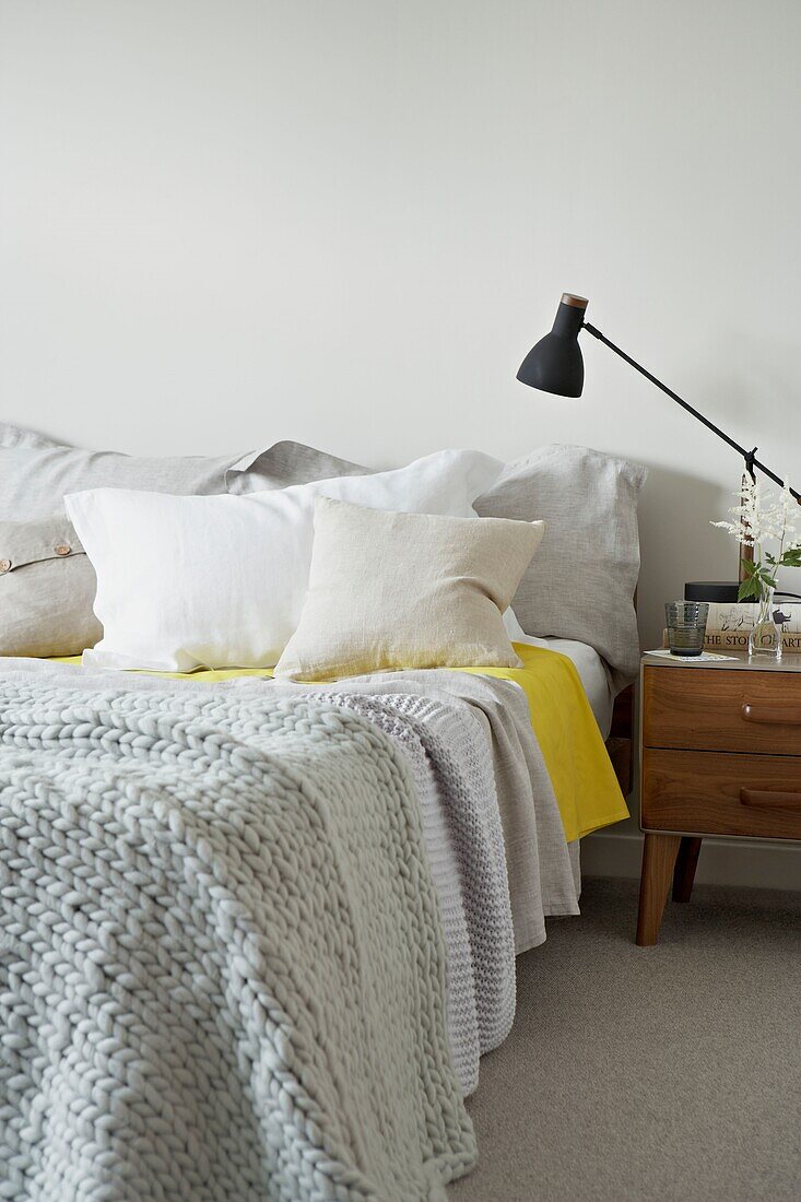 Woollen blanket on unmade bed   London   UK