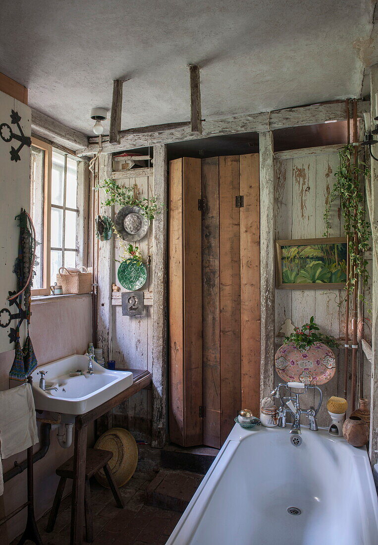 Kleines Badezimmer mit hölzerner Falttür in Benenden cottage, Kent, England, UK