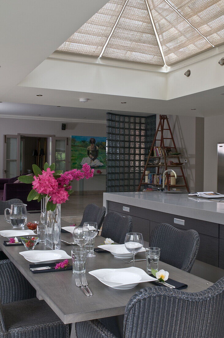 Light grey open plan kitchen and dining room in contemporary Haywards Heath home,  West Sussex,  England,  UK