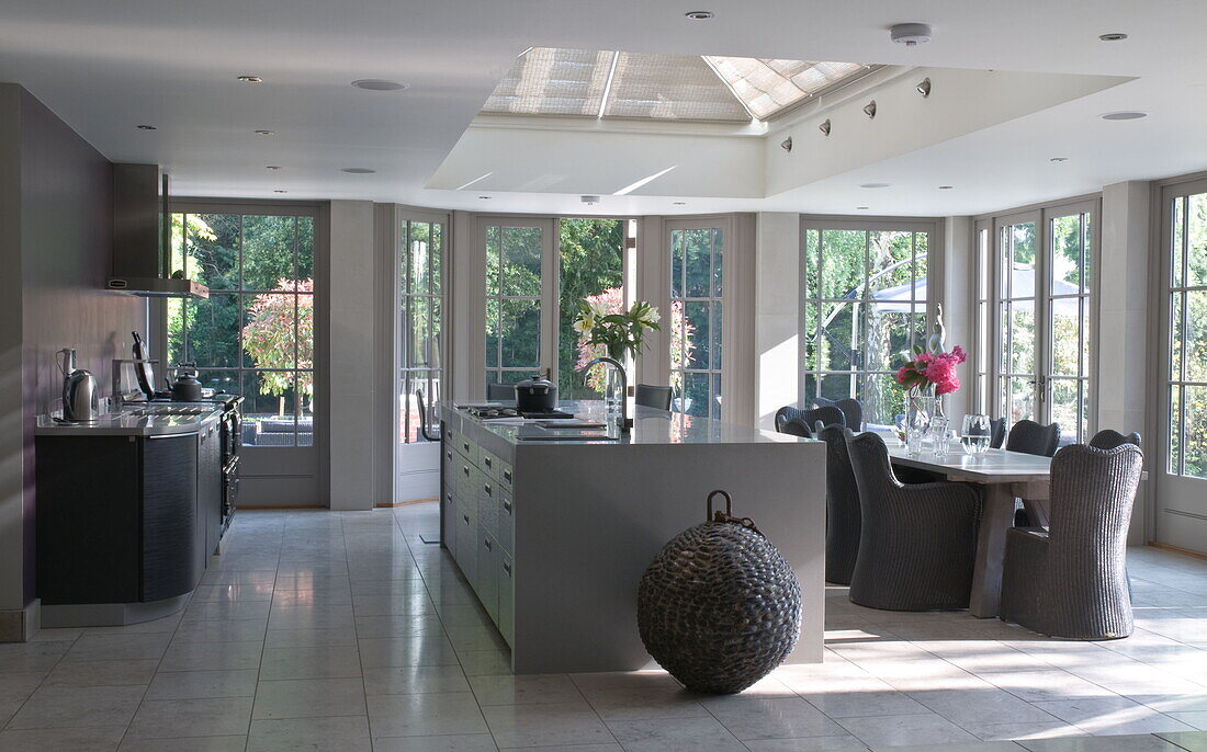 Hellgraue offene Küche und Esszimmer in modernem Haus in Haywards Heath, West Sussex, England, UK