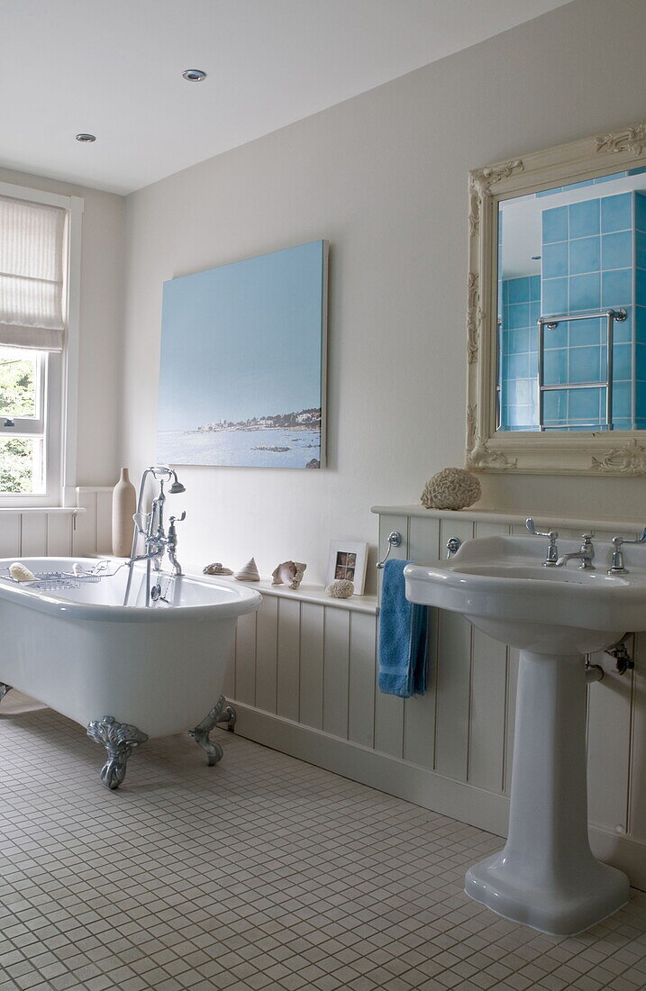 White freestanding claw-foot bath with pedestal basin in contemporary Haywards Heath home,  West Sussex,  England,  UK