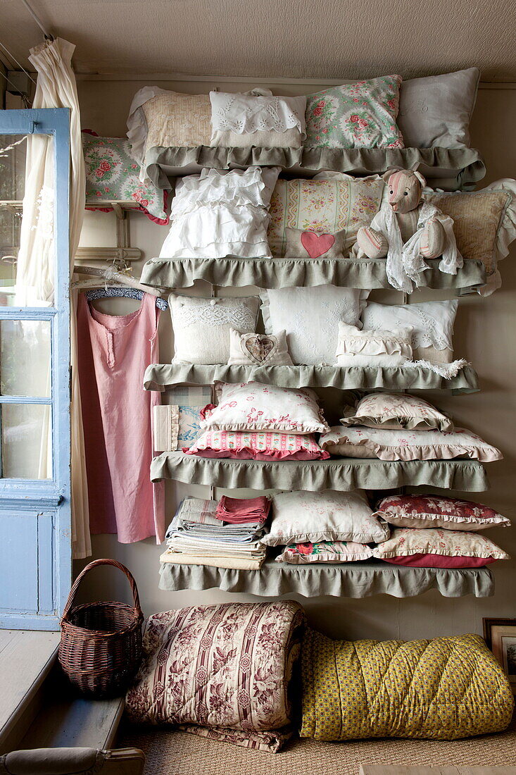 Assorted cushions on shelving in fabric shop,  Dordogne,  France