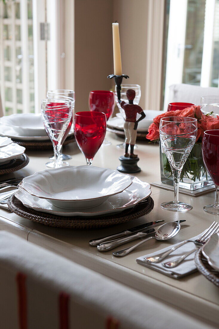 Place setting with red wineglasses on dining table in Battersea home,  London,  England,  UK