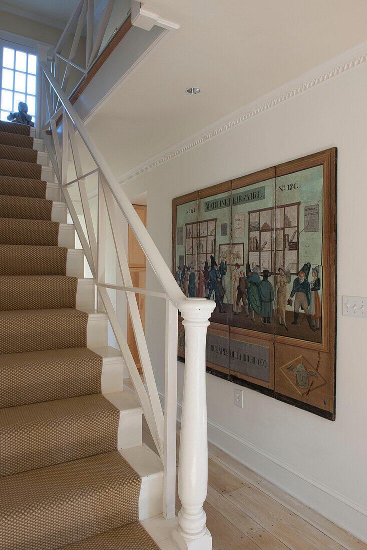 Seagrass staircase and historical artwork in hallway of Washington DC home,  USA