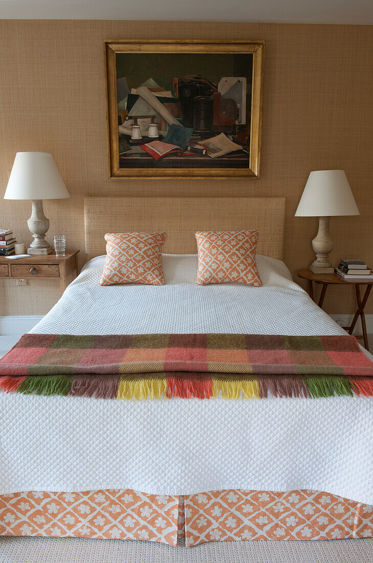 Blanket on bed with co-ordinated valence and pillows with artwork in Washington DC home,  USA
