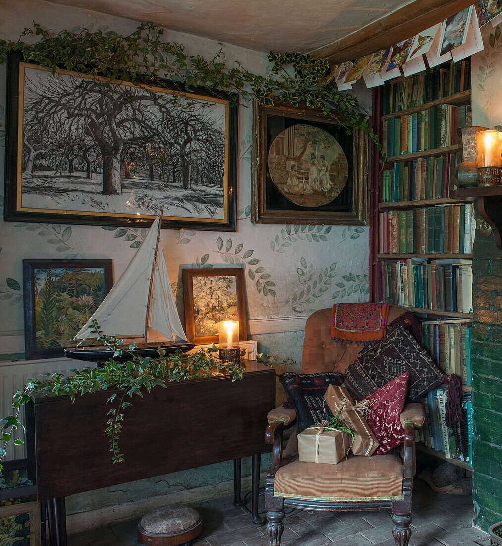 Model boat on drop-leaf table with bookcase in corner of Benenden cottage,  Kent,  England,  UK