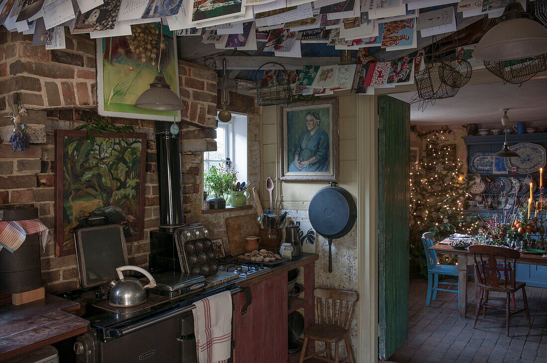 Christmas cards hang in exposed brick kitchen of Benenden cottage,  Kent,  England,  UK