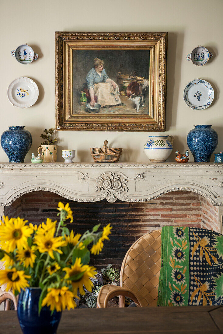 Sunflowers on kitchen table with gilt framed artwork in Dordogne cottage  Perigueux  France