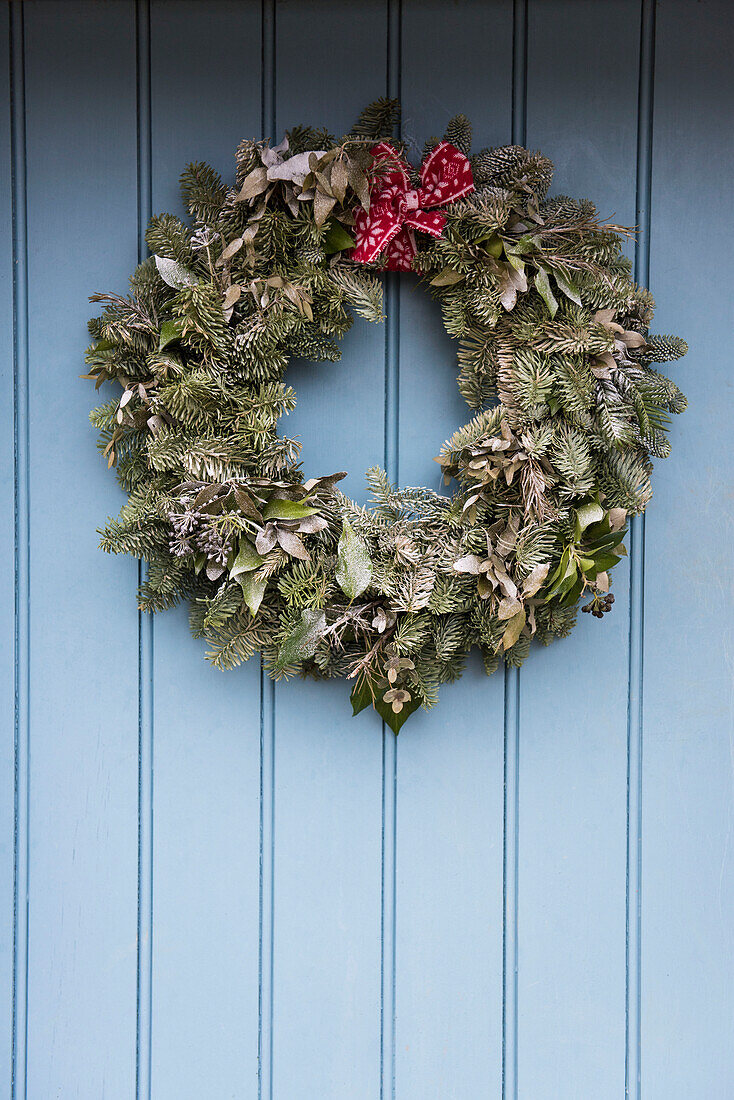 Christmas wreath on  light blue door of Grade II cottage  Kent