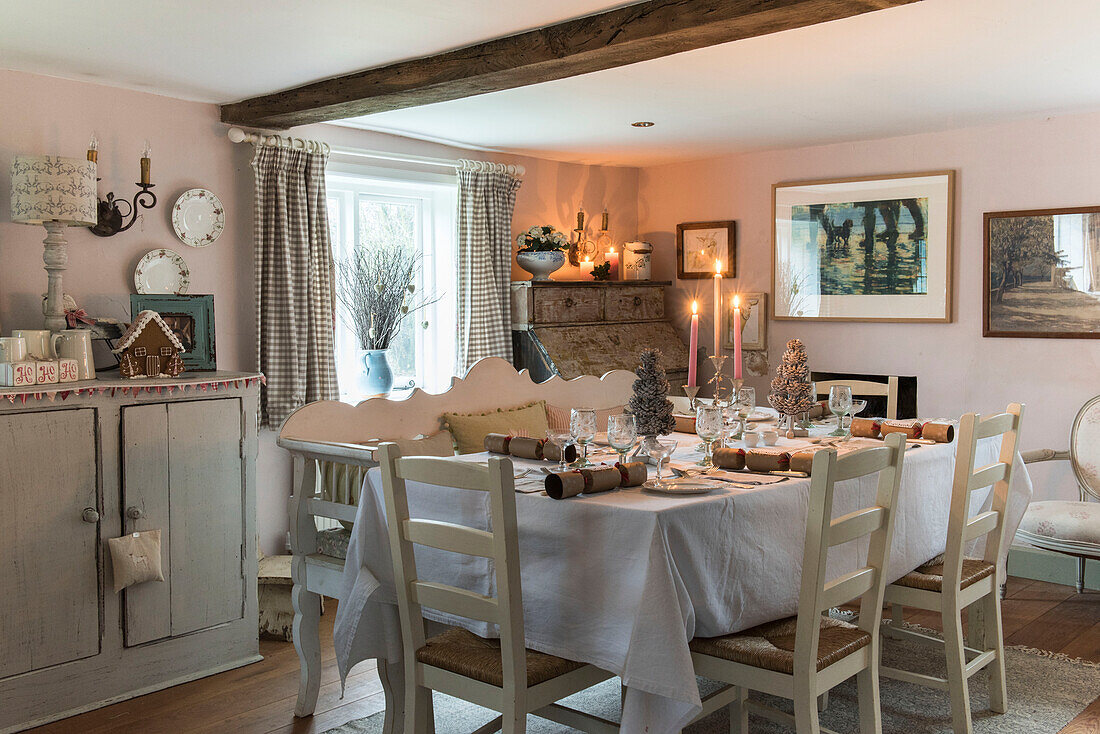Dining table with white cloth at Christmas in Grade II listed cottage  Kent