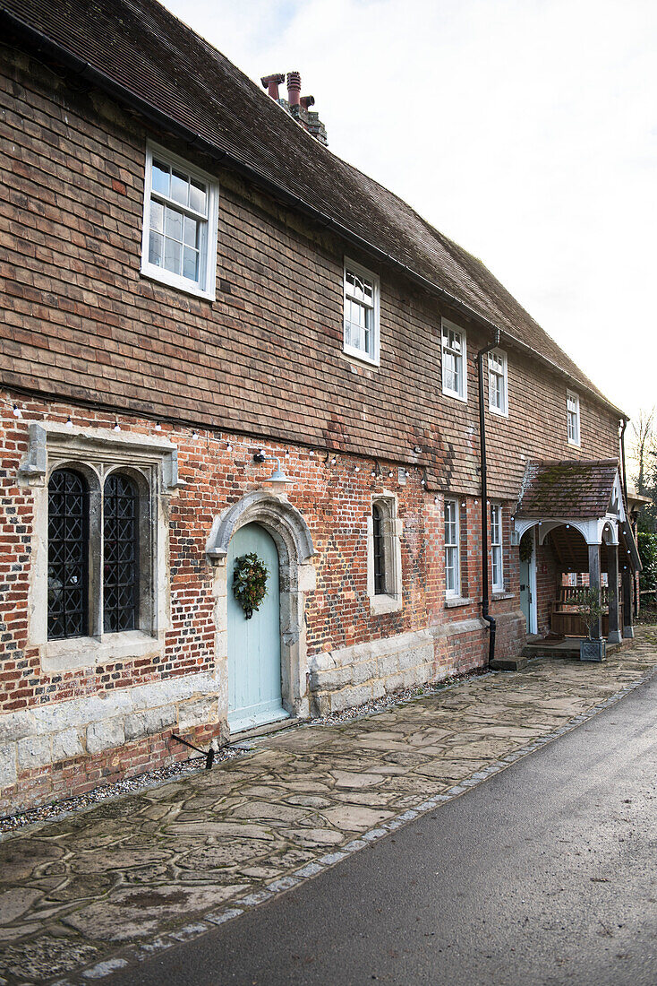 Brick exterior with two front doors of Grade II Listed priory  Headcorn  Kent  UK