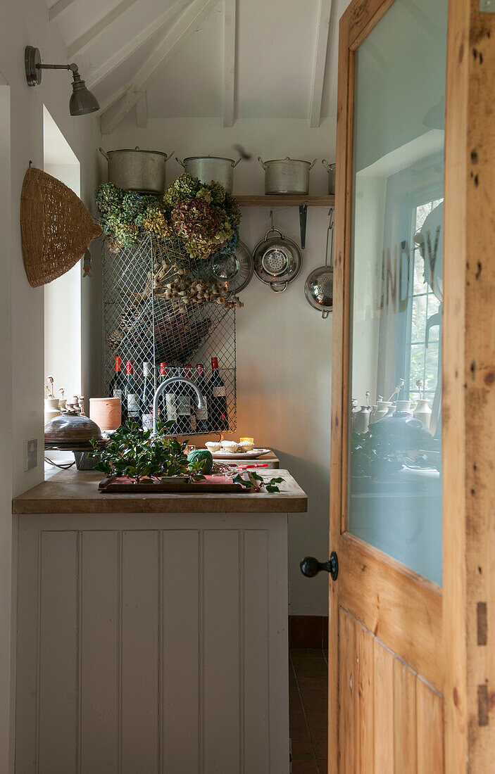 View through glass paned doorway to kitchen sing in Kilndown cottage  Kent  England  UK